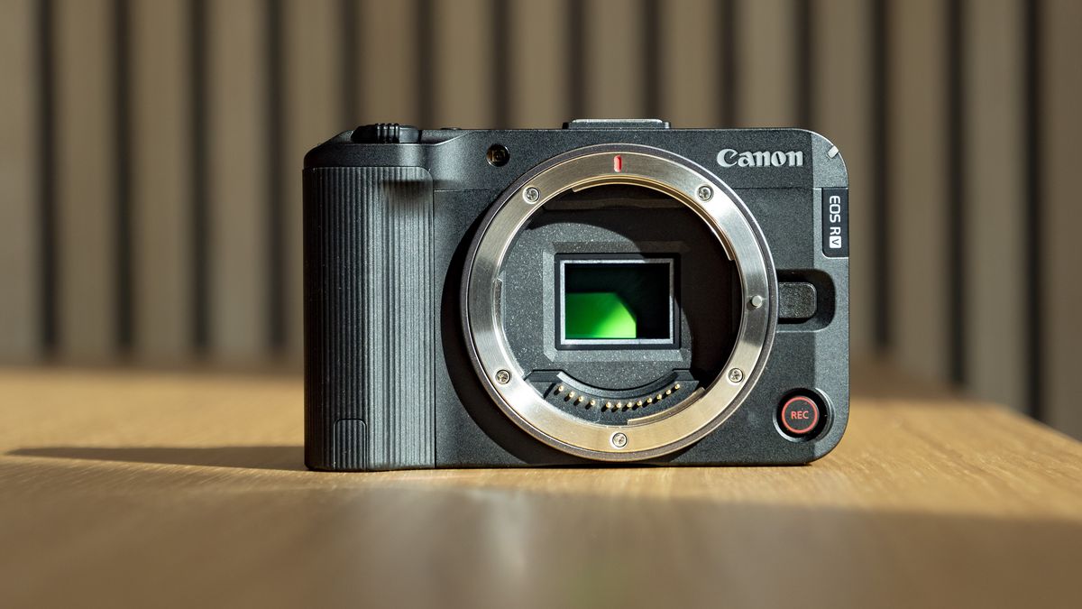 Canon EOS R50 V on a wooden table, no lens