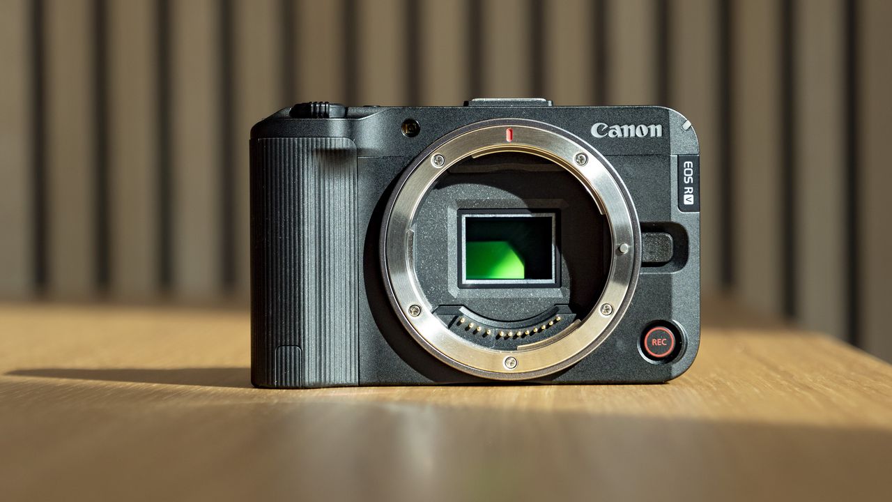 Canon EOS R50 V on a wooden table, no lens