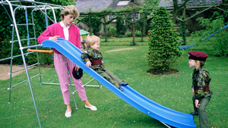 Princess Diana At Highgrove With Prince William And Prince Harry Dressed In Miniature Parachute Regiment Uniforms And Playing On Their Slide In The Garden in 1986