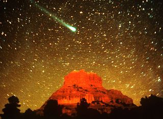 Comet Hyakutake soars above a mesa.