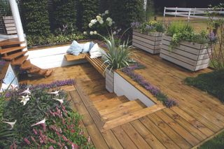 A small backyard with built-in planters, steps and built-in floating bench