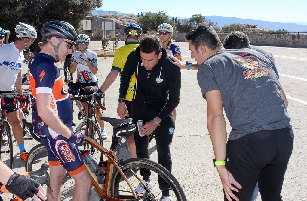 Spanish staff marvel at a local riders' wooden Renovo bicycle.
