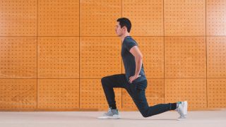 Man performs lunge bodyweight exercise