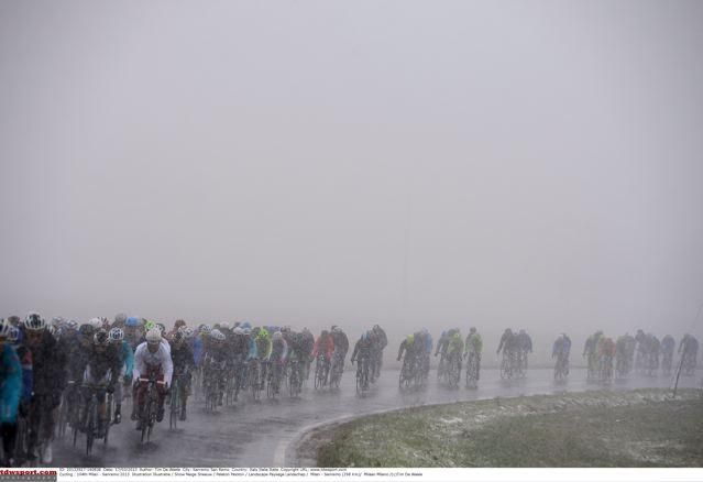 The peloton fights the snow on the Lombardy plain