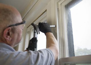 a worker repairing sash windows