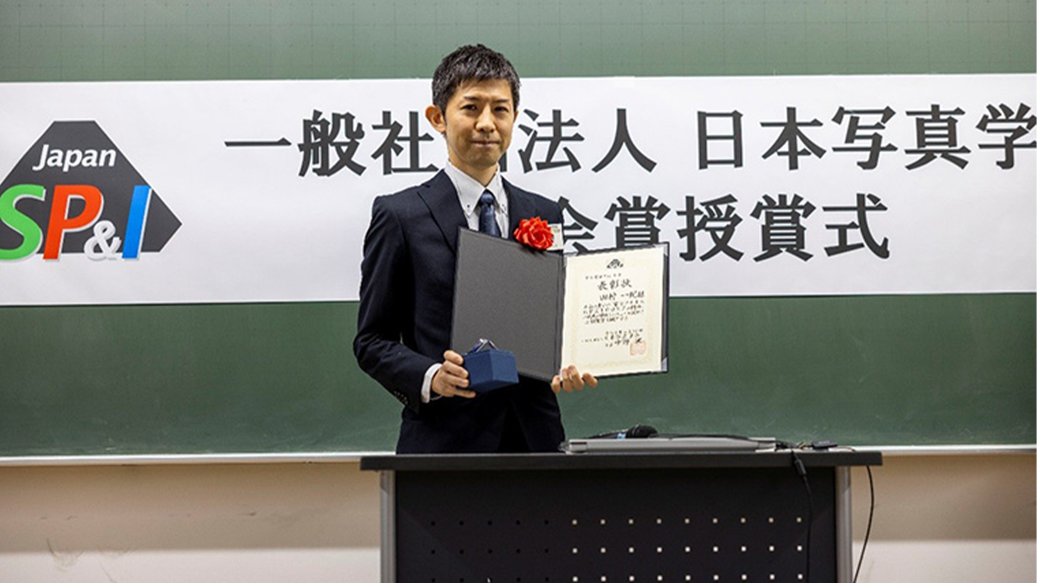 Man holding certificate.