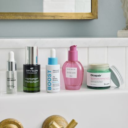 multiple skincare products on bathroom shelf