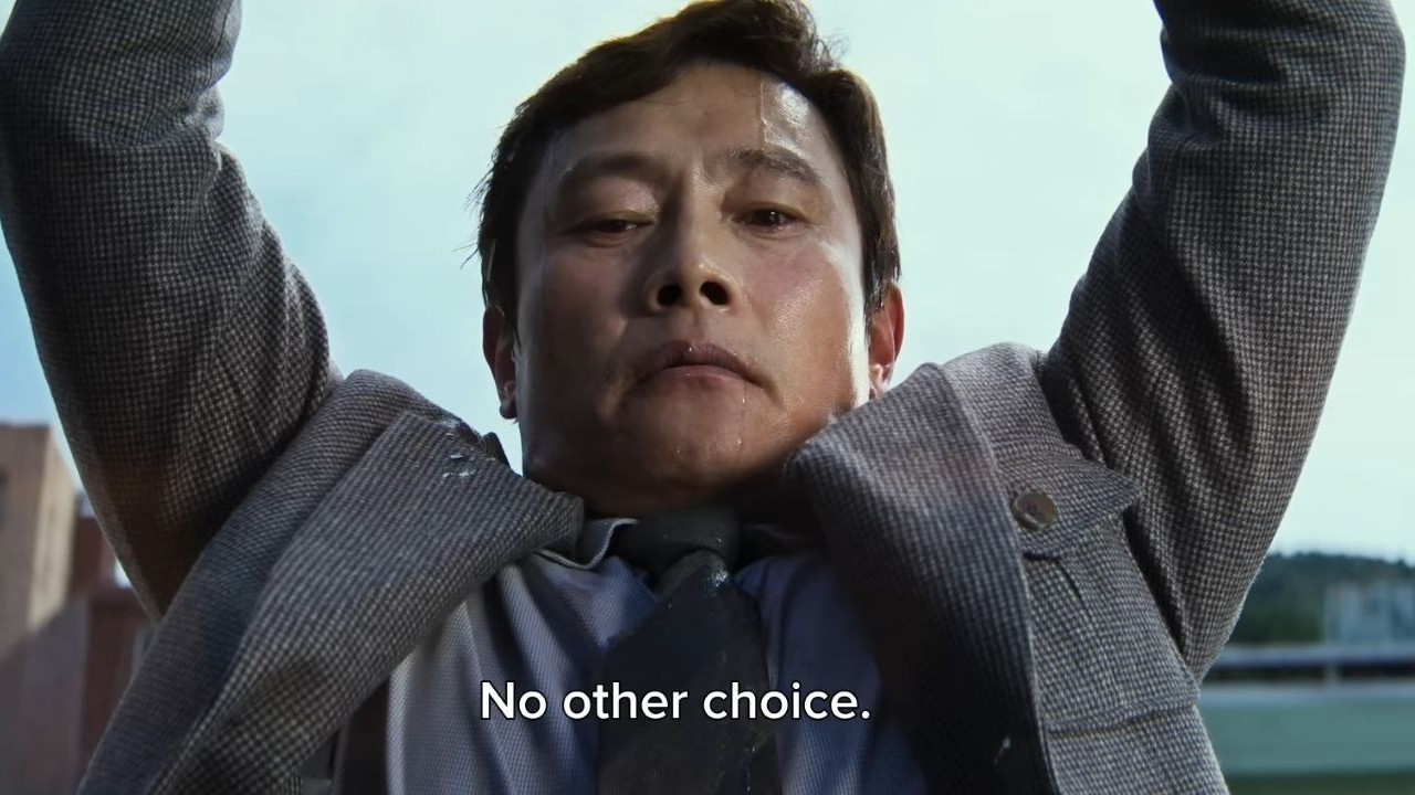 Lee Byung-hun lifting pot in No Other Choice.