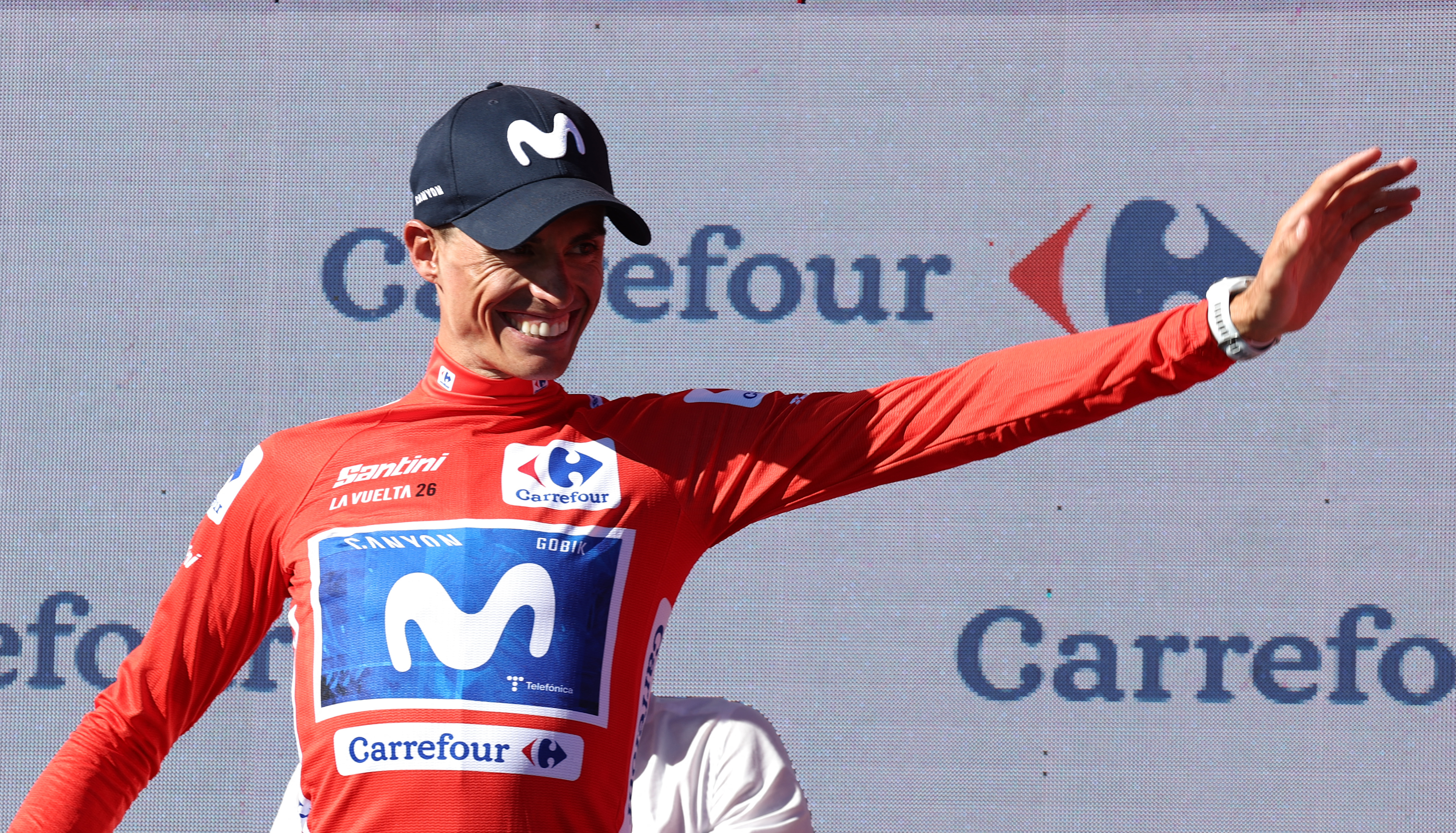 Overall leader Team Movistar's Spanish rider Enric Mas celebrates on the podium after winning the 9th stage of the Vuelta a Espana 2026 cycling tour, a 187,4 km race between Villajoyosa and Alto de Aitana in Confrides, on August 30, 2026. (Photo by Josep LAGO / AFP)