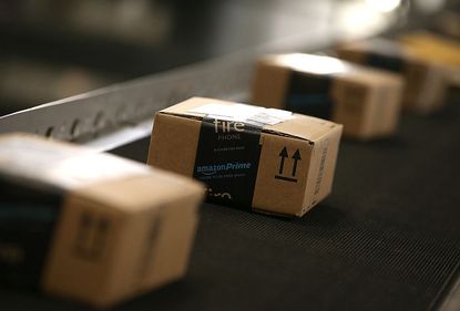 Amazon boxes on conveyor belt.