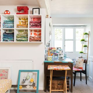 sewing room with white wall and window