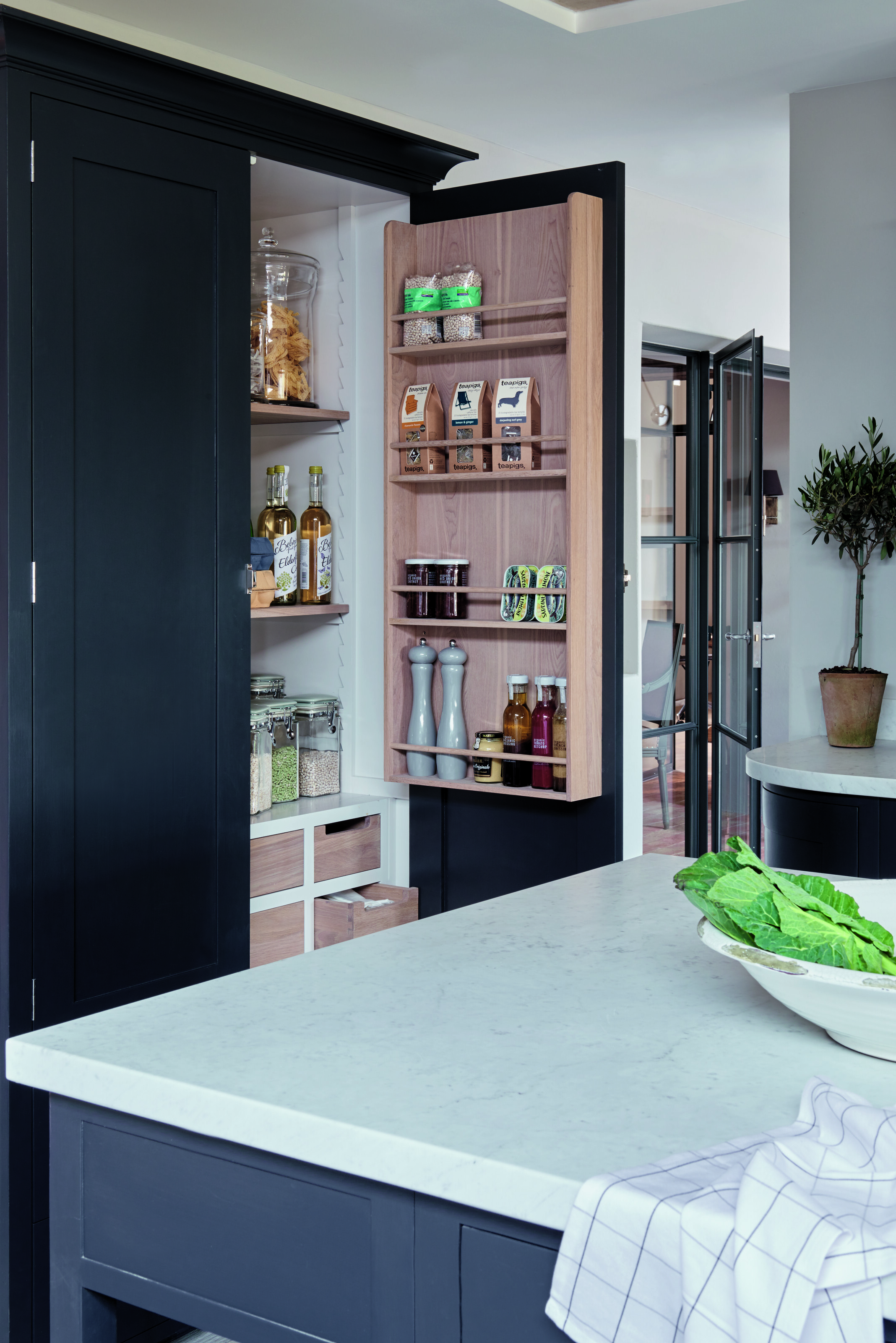 open pantry door with food inside in a kitchen