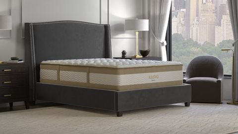Saatva RX mattress review image shows Saatva's new mattress for back pain placed on a grey bed frame