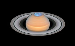 A composite image puts the Hubble Space Telescope's measurements of Saturn's ultraviolet northern auroras on top of a visible-light image of the planet. Hubble measured Saturn's auroras during the months surrounding its northern solstice to learn more about the planet's magnetic field.