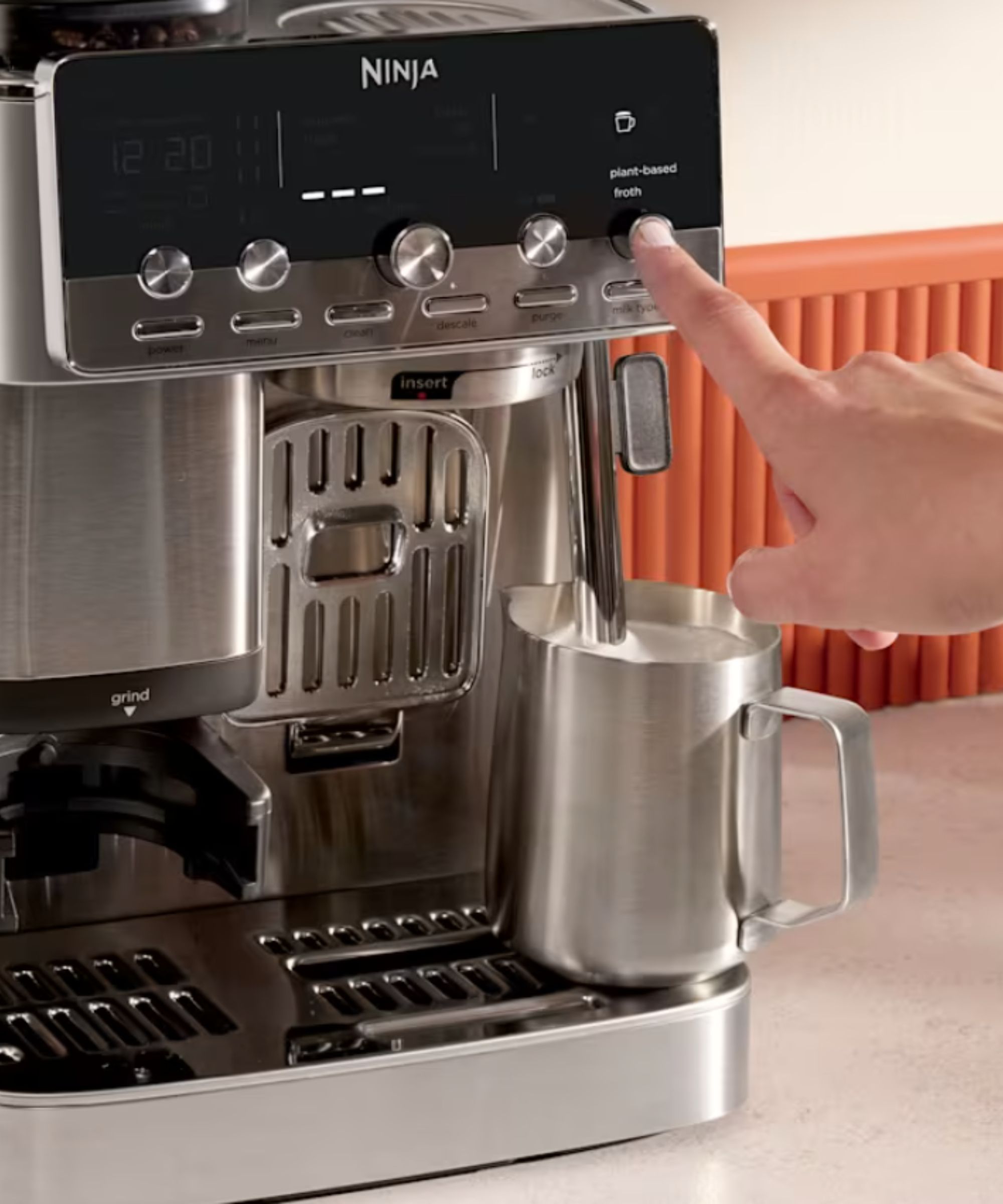 Someone steaming milk with the Ninja Luxe Caf&eacute; Mini Plus Espresso Machine