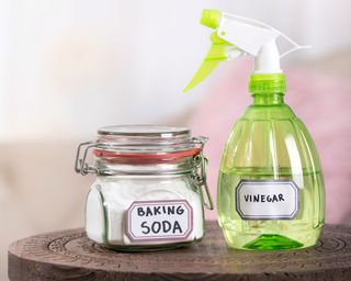spray bottle with vinegar and baking soda - GettyImages-1218750111