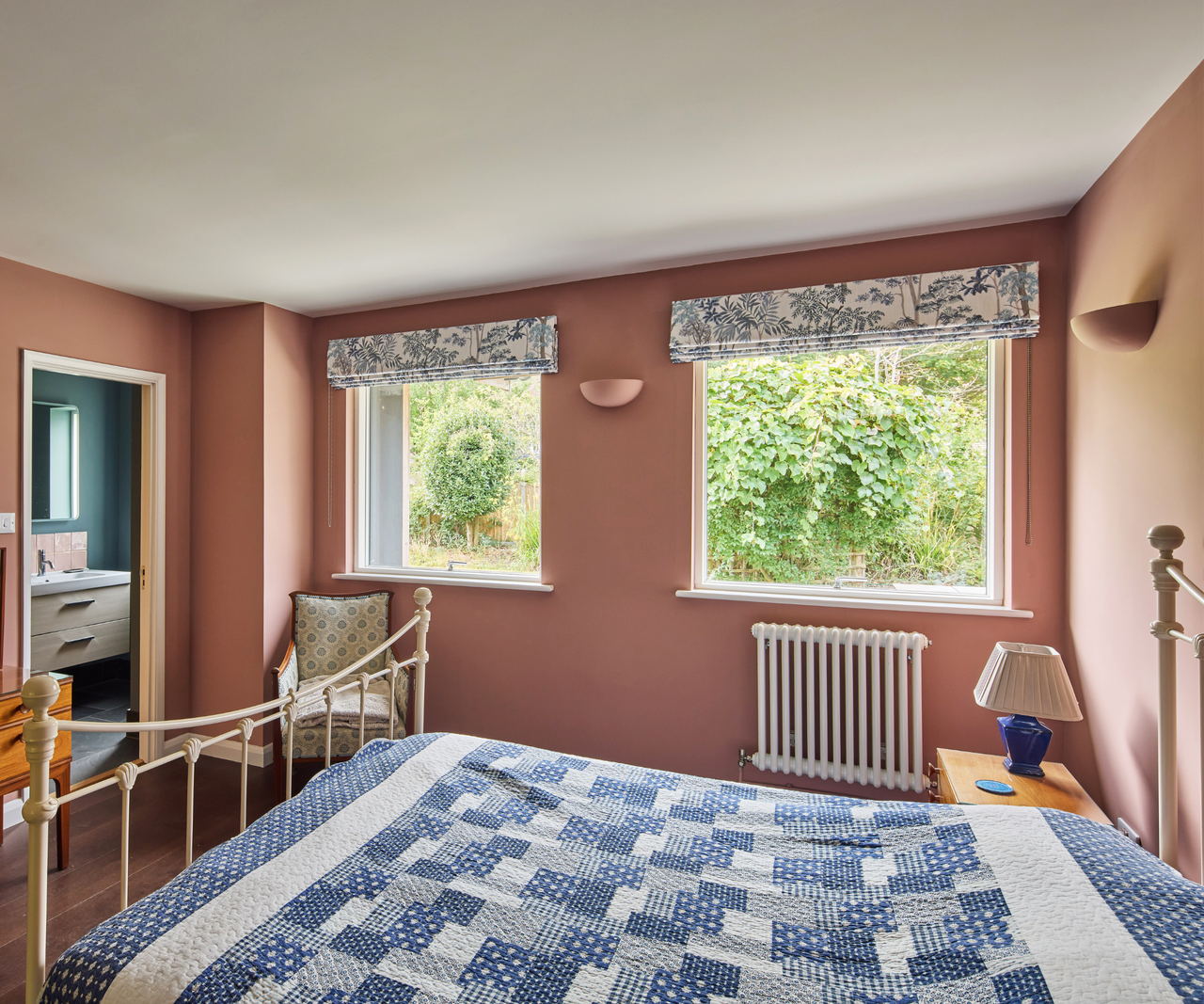 Bedroom with two windows and pink walls