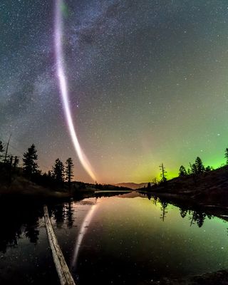 A bright diagonal purple line of light in the sky