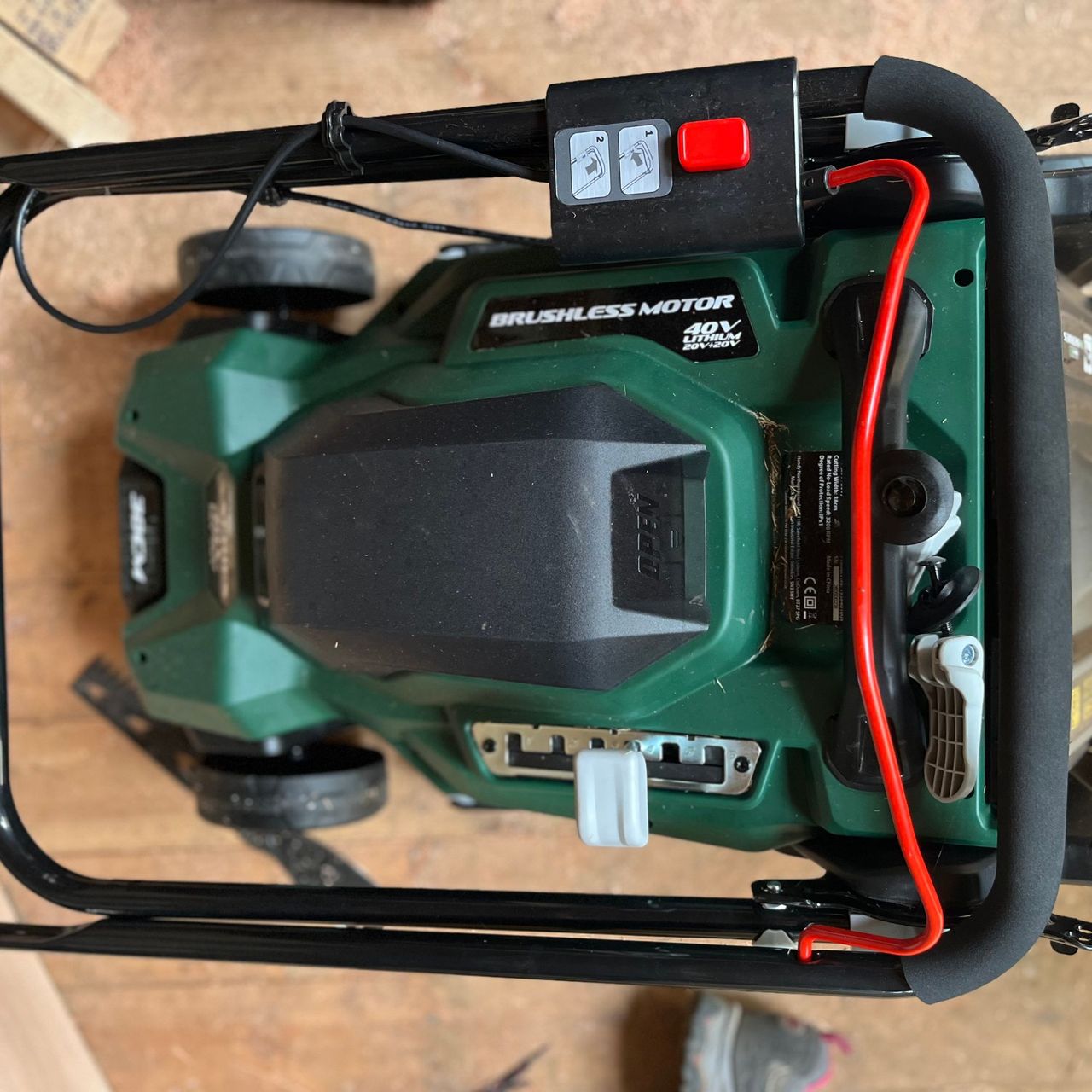 webb 40v lawn mower with folded handle bar in shed
