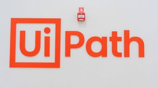 UiPath logo and branding pictured on a wall at the company's headquarters in Bucharest, Romania.