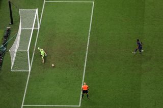 France midfielder Aurelien Tchouameni drags his penalty wide as Argentina goalkeeper Emiliano Martinez dives to his left in the 2022 World Cup final.