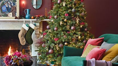 mauve living room with christmas tree and fireplace