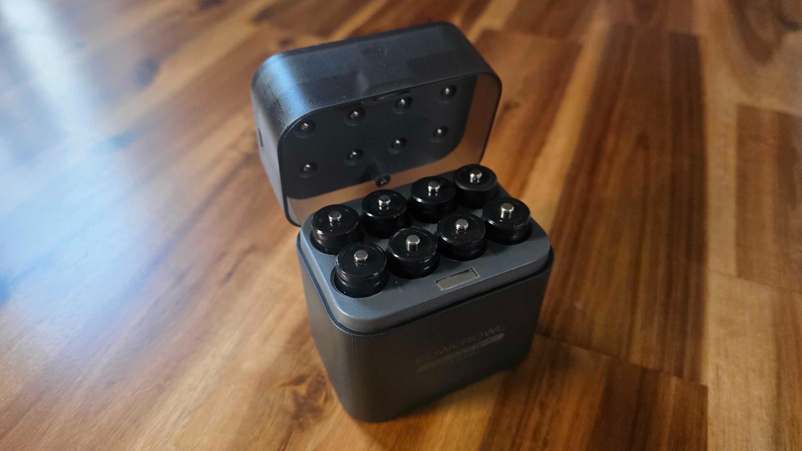 Powerowl Lithium rechargeable batteries and case on a table