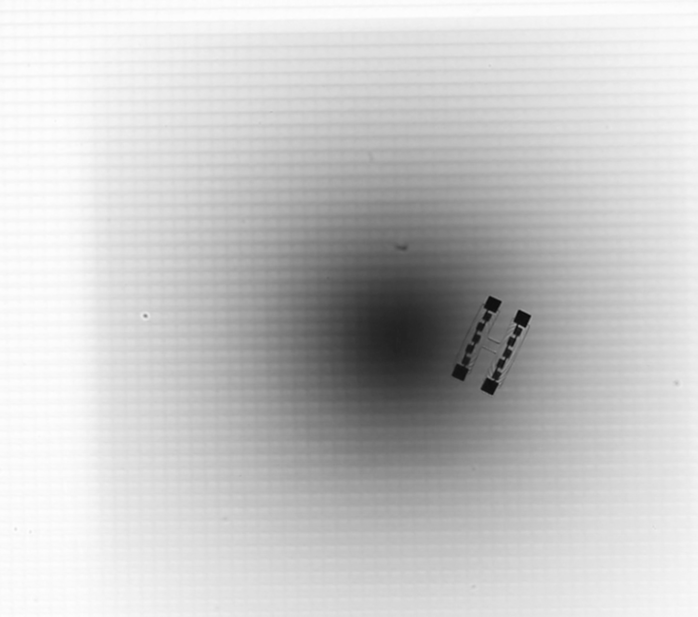 Two parallel dark lines sit next to a blurred black circle in the center of the image.