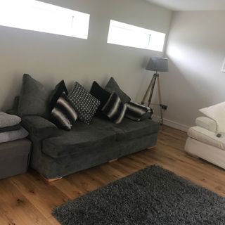 living room with sofa set with cushions