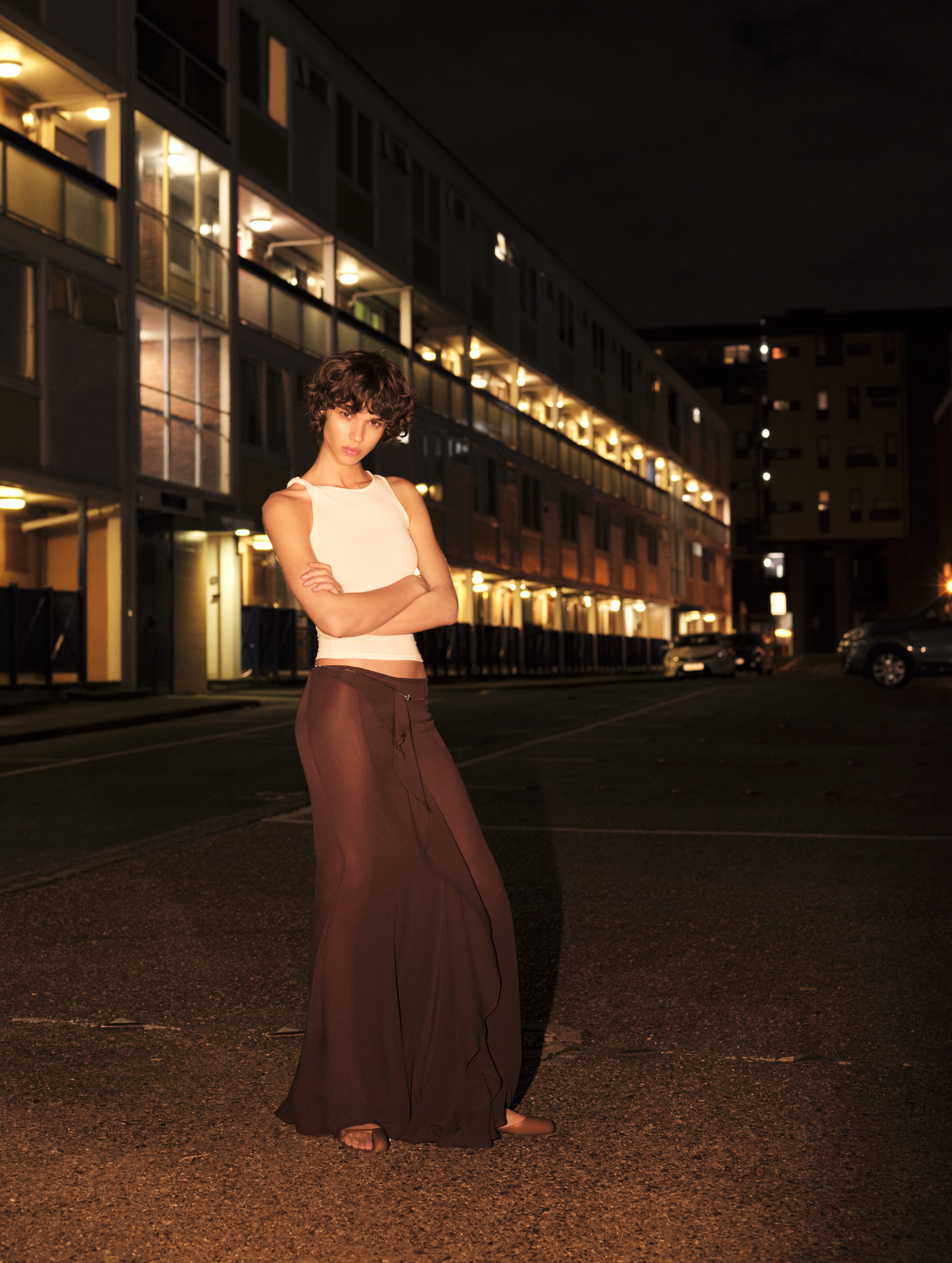 a model poses on a London street at night wearing Supriya Lele for Mango
