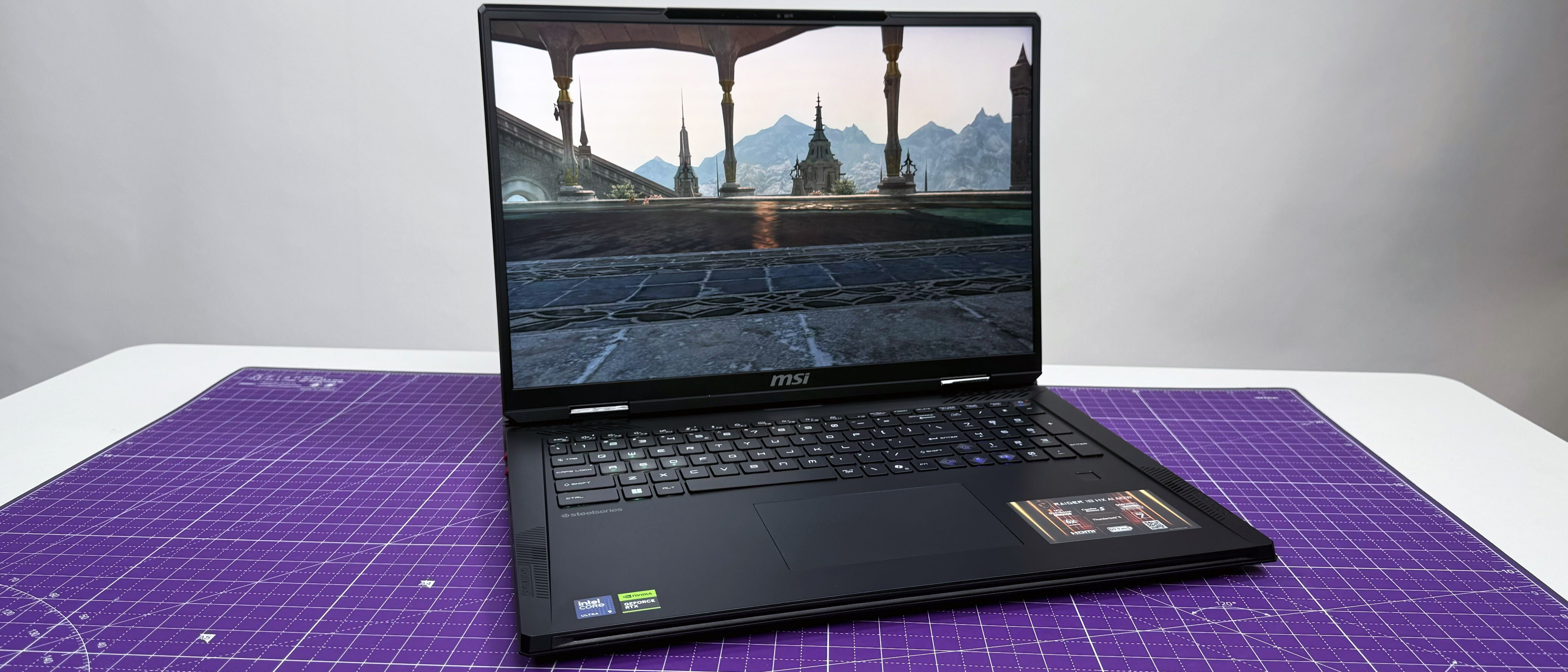 The MSI Raider 18 HX AI gaming laptop open facing on a purple mat against a gray background.