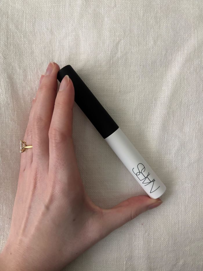 Deputy beauty editor Grace Lindsay holding the Nars Pro Prime Smudge Proof Eyeshadow Base