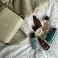 M&S perfumes shot as a group with a cream YSL handbag