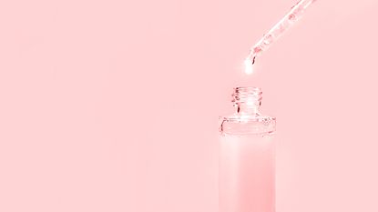 Pipette bottle against pink background