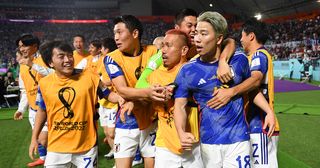 Takuma Asano of Japan celebrates scoring their second goal with their teammates during the FIFA World Cup Qatar 2022 Group E match between Germany and Japan at Khalifa International Stadium on November 23, 2022 in Doha, Qatar.