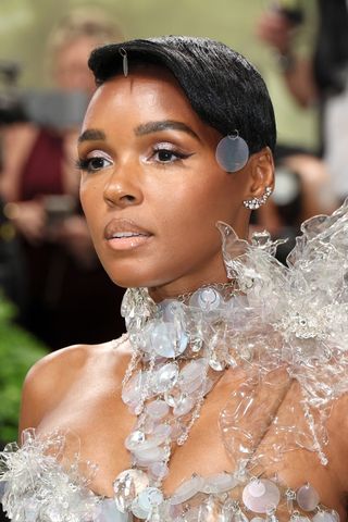 Janelle Monáe is pictured with short hair, which is styled into a sleek, side-fringe look at The 2024 Met Gala Celebrating "Sleeping Beauties: Reawakening Fashion" at The Metropolitan Museum of Art on May 06, 2024 in New York City.