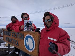 NASA engineers Mark Sinkiat, Peter Fetterer and Salem El-nimri pose at McMurdo Station in Antarctica with a picture of Vint Cerf, a visiting scientist at NASA's Jet Propulsion Laboratory, who helped develop the disruption-tolerant networking (DTN) technology that sent the selfie to the International Space Station.