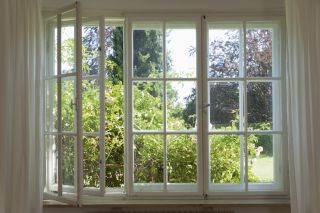 wooden casement windows open to the outside