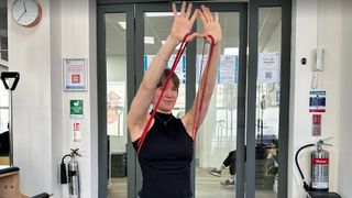 Woman performing resistance band triceps extensions