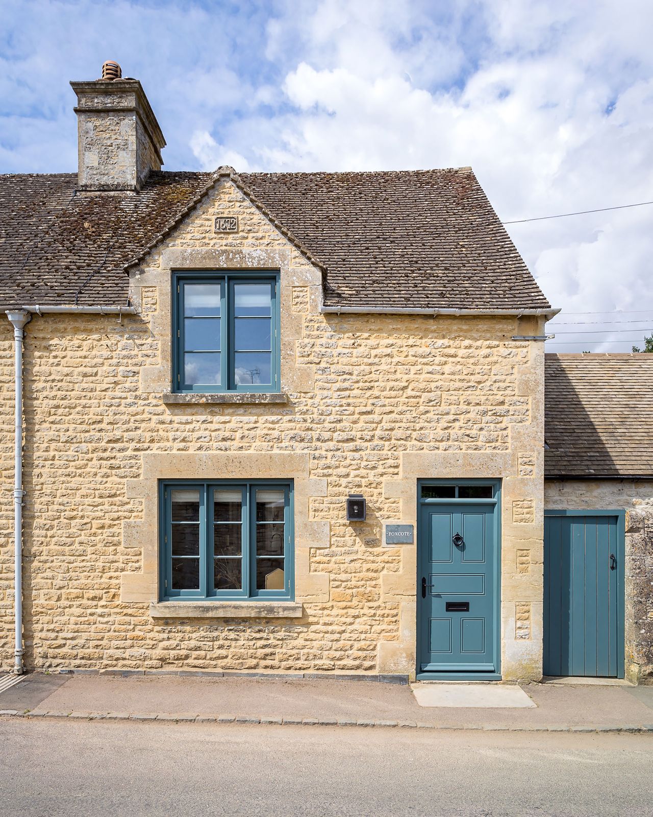 stone cottage with blue windows and doors