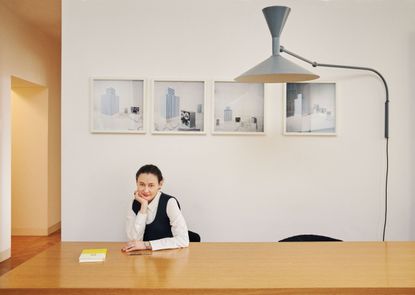 A portrait of Maria Cristina Didero sitting at a table in her Milan home