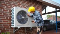 Air source heat pump fitted outside a new home development