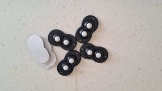 Black self-adhesive mini caster wheels on white kitchen counter