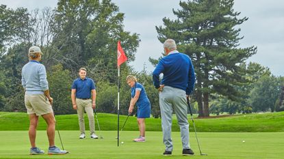 A generic image of golfers on a green