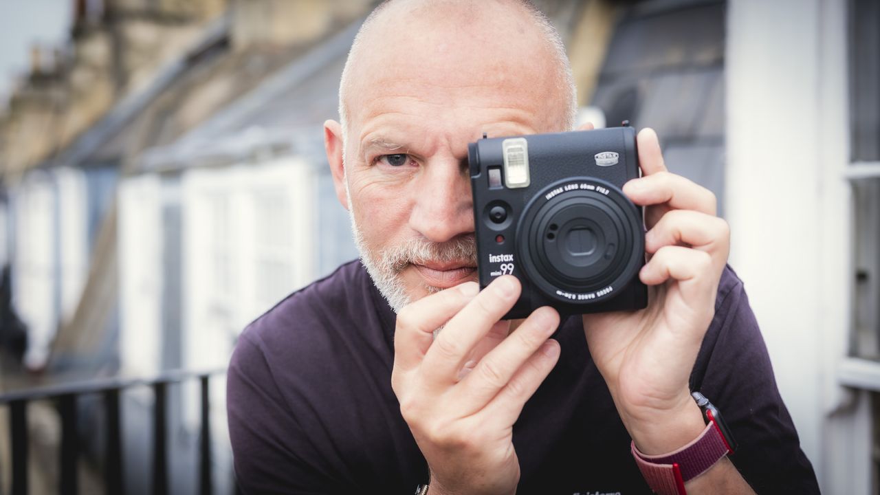 Fujifilm Instax Mini 99 held up to the eye