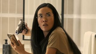 Ali Wong pointing a gun at a phone in BEEF
