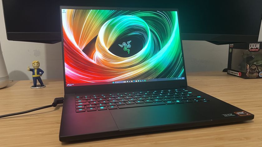 Razer Blade 14 gaming laptop on a wooden desk 