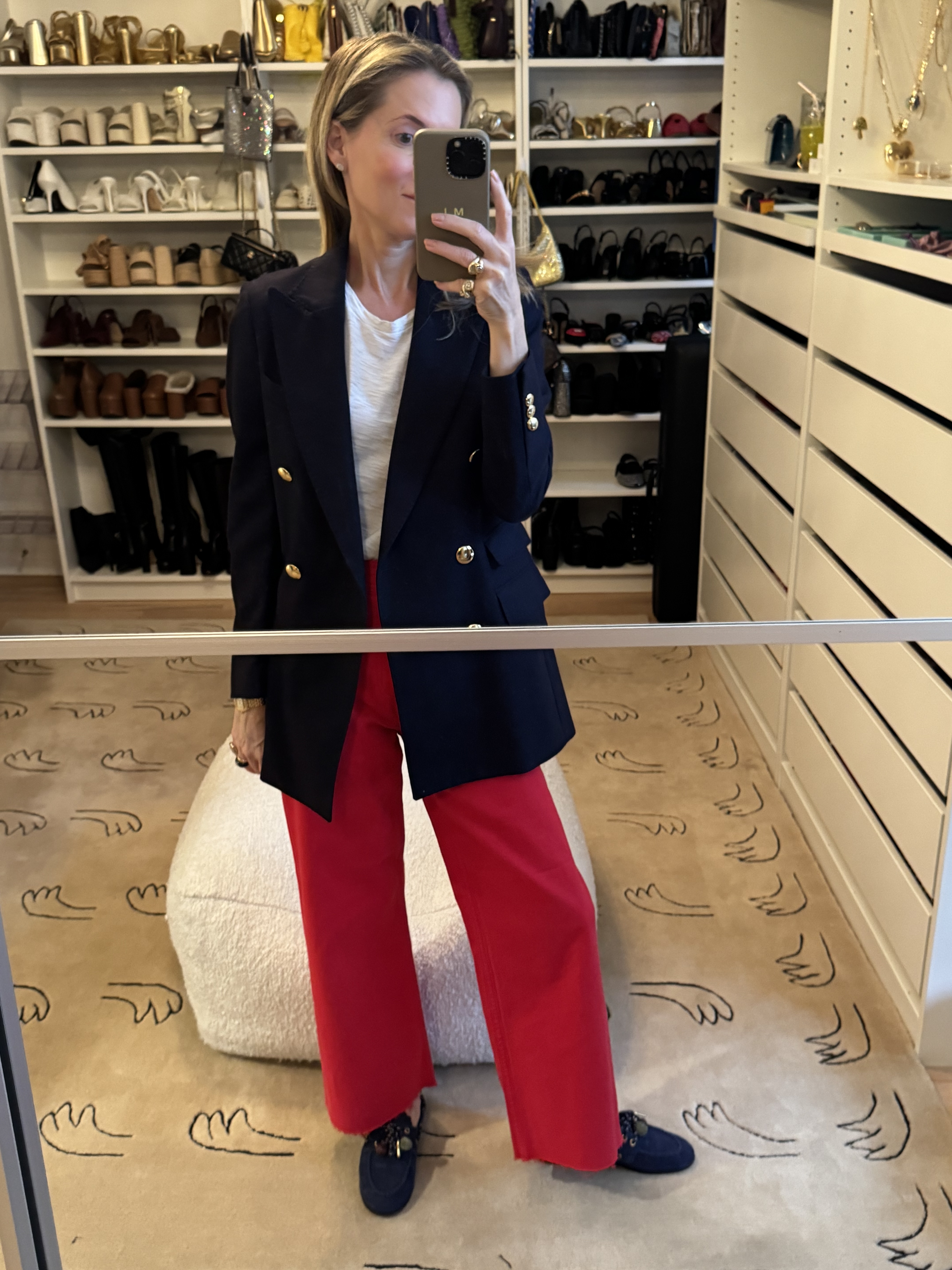 Marina Larroud&amp;eacute; wearing red jeans, a white T-shirt, and a navy blazer