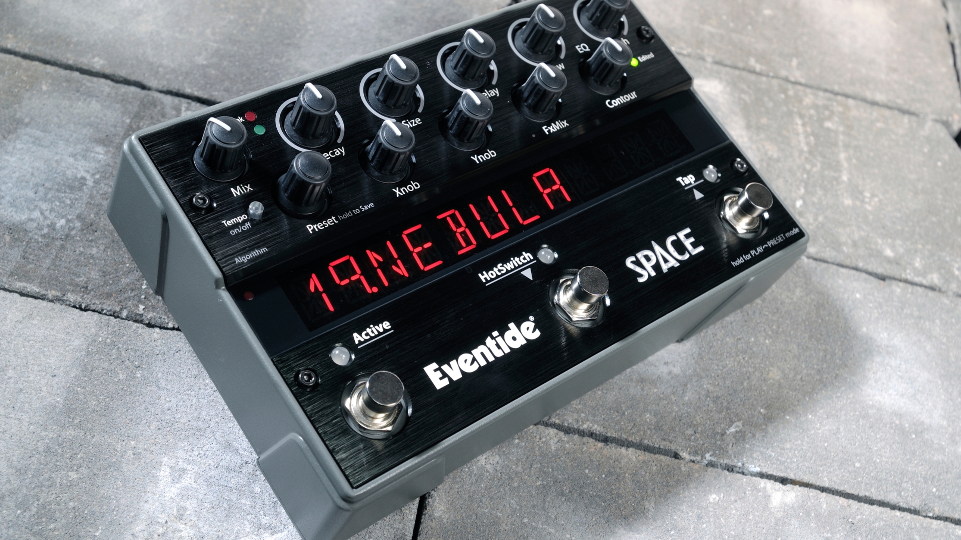 An Eventide Space reverb pedal lying on a concrete floor