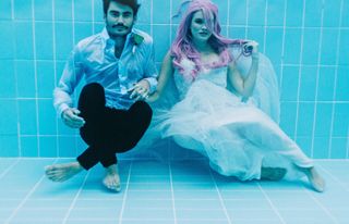 A couple under water in a pool